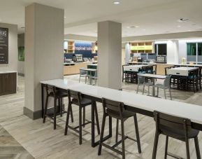 Dining area and workspace at Home2 Suites By Hilton Cape Canaveral Cruise Port.