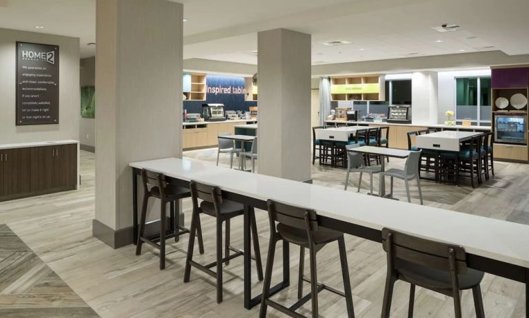 Dining area and workspace at Home2 Suites By Hilton Cape Canaveral Cruise Port.