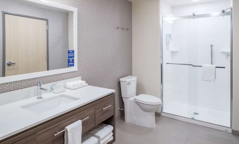 Private guest bathroom with shower and free toiletries at Home2 Suites By Hilton Cape Canaveral Cruise Port.