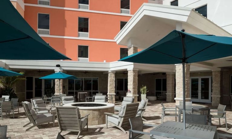 Patio with lounge seating and fire pit at Home2 Suites By Hilton Cape Canaveral Cruise Port.
