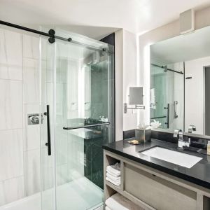Private guest bathroom with shower and free toiletries at DoubleTree By Hilton Washington DC North/Gaithersburg.