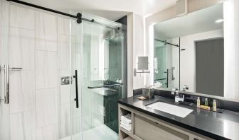 Private guest bathroom with shower and free toiletries at DoubleTree By Hilton Washington DC North/Gaithersburg.