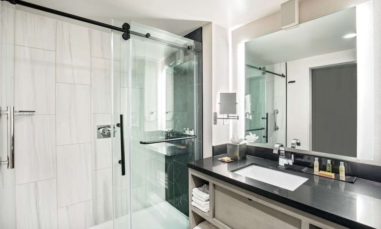 Private guest bathroom with shower and free toiletries at DoubleTree By Hilton Washington DC North/Gaithersburg.