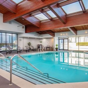 Relaxing indoor pool with lounge chairs at DoubleTree By Hilton Washington DC North/Gaithersburg.