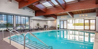 Relaxing indoor pool with lounge chairs at DoubleTree By Hilton Washington DC North/Gaithersburg.