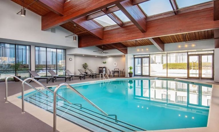 Relaxing indoor pool with lounge chairs at DoubleTree By Hilton Washington DC North/Gaithersburg.