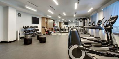 Well equipped fitness center at The Rose Hotel Chicago O’Hare, Tapestry Collection By Hilton.