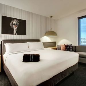 Day use room with sofa and work desk at The Rose Hotel Chicago O’Hare, Tapestry Collection By Hilton.