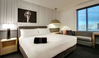 Day use room with sofa and work desk at The Rose Hotel Chicago O’Hare, Tapestry Collection By Hilton.