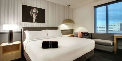 Day use room with sofa and work desk at The Rose Hotel Chicago O’Hare, Tapestry Collection By Hilton.