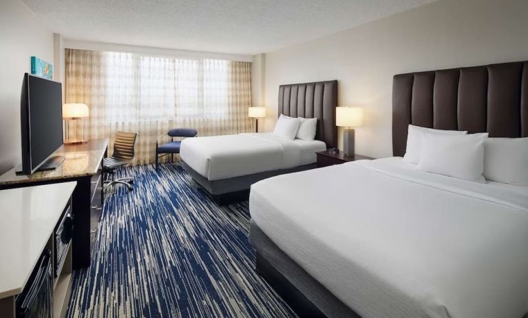 Bright and spacious day use twin room with work desk at Embassy Suites By Hilton West Palm Beach Central.