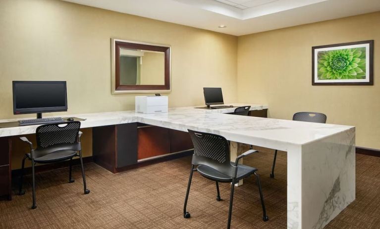Business center with computers, printer and comfortable seating at Embassy Suites By Hilton West Palm Beach Central.