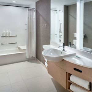 Private guest bathroom with combined shower and tub at 	SpringHill Suites Atlanta Northwest.