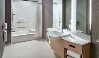 Private guest bathroom with combined shower and tub at 	SpringHill Suites Atlanta Northwest.