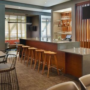 On-site bar with lounge seating and workspace, perfect for coworking at 	SpringHill Suites Atlanta Northwest.