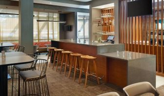 On-site bar with lounge seating and workspace, perfect for coworking at 	SpringHill Suites Atlanta Northwest.