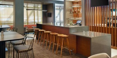 On-site bar with lounge seating and workspace, perfect for coworking at 	SpringHill Suites Atlanta Northwest.