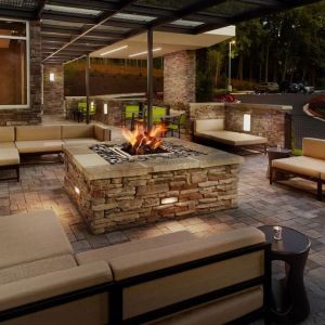 Patio with lounge seating and fire pit at 	SpringHill Suites Atlanta Northwest.