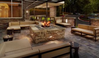 Patio with lounge seating and fire pit at 	SpringHill Suites Atlanta Northwest.
