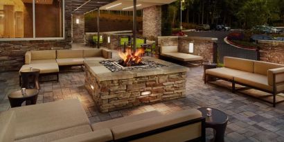 Patio with lounge seating and fire pit at 	SpringHill Suites Atlanta Northwest.