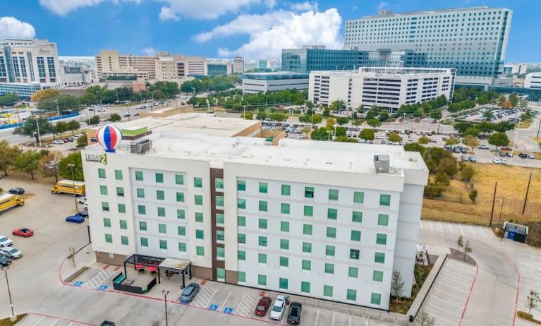 Exterior view of Home2 Suites By Hilton Dallas Medical District Lovefield and its parking area. 