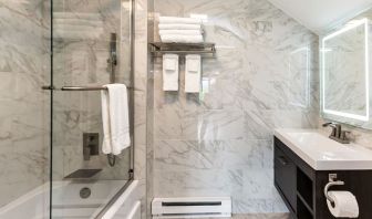 Private guest bathroom with combined shower and tub at SKYLARANNA Resort & Spa.