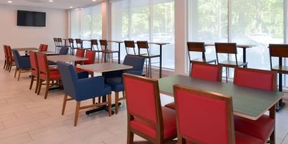 Dining area with comfortable seating at Holiday Inn Express Towson Baltimore North.