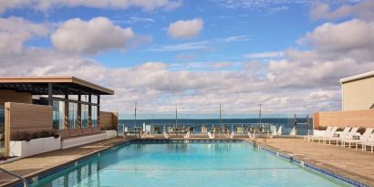 Outdoor pool with lounge chairs at Sea Crest Beach Hotel.