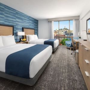 Day use twin room with work desk and floor to ceiling window at Hotel Caza.