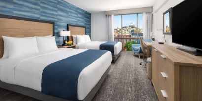 Day use twin room with work desk and floor to ceiling window at Hotel Caza.