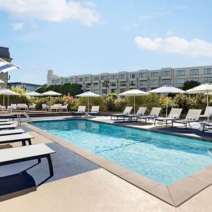 Outdoor pool with lounge chairs at Hotel Caza.