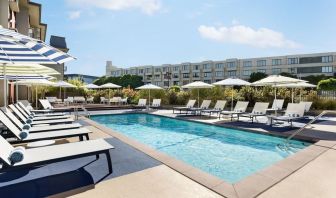 Outdoor pool with lounge chairs at Hotel Caza.