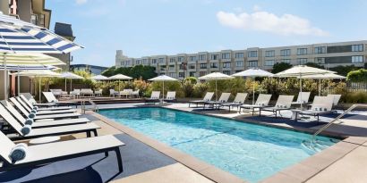 Outdoor pool with lounge chairs at Hotel Caza.