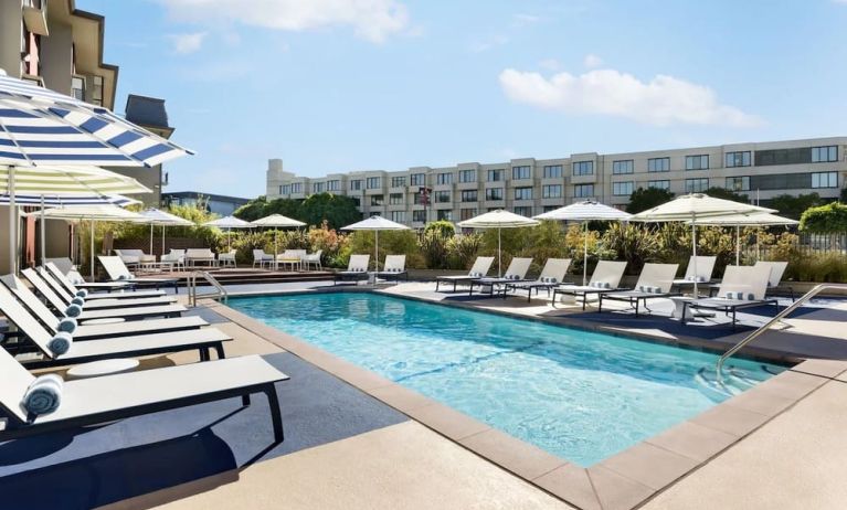 Outdoor pool with lounge chairs at Hotel Caza.