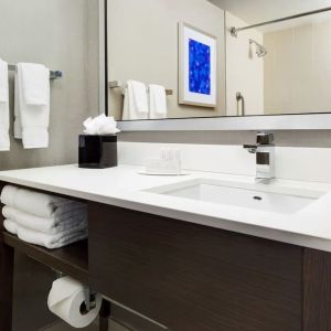 Private guest bathroom with shower and free toiletries at Courtyard Boston Cambridge.