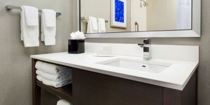 Private guest bathroom with shower and free toiletries at Courtyard Boston Cambridge.