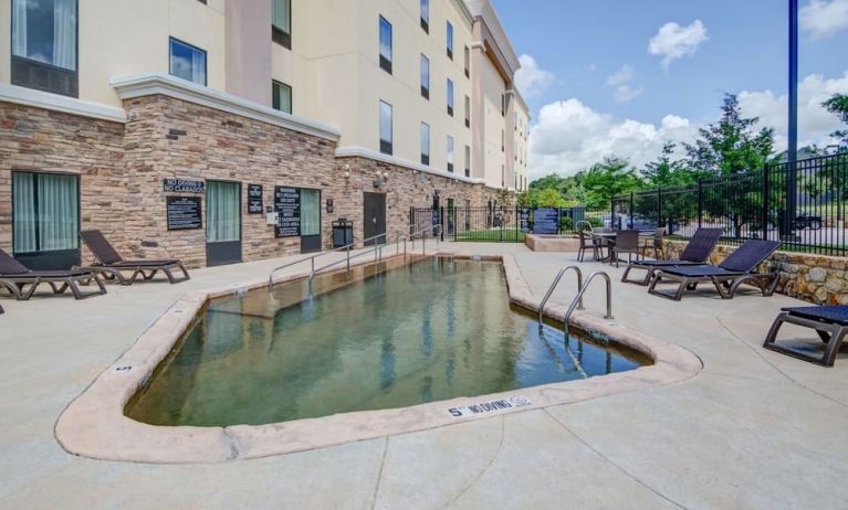 Outdoor pool with lounge chairs at Hampton Inn & Suites Trophy Club - Fort Worth North, TX.