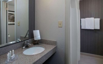 Private guest bathroom with shower and free toiletries at Sonesta Select Atlanta Norcross I-85.