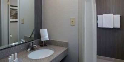 Private guest bathroom with shower and free toiletries at Sonesta Select Atlanta Norcross I-85.