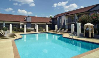 Outdoor pool with lounge chairs at Sonesta Select Atlanta Norcross I-85.