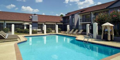 Outdoor pool with lounge chairs at Sonesta Select Atlanta Norcross I-85.