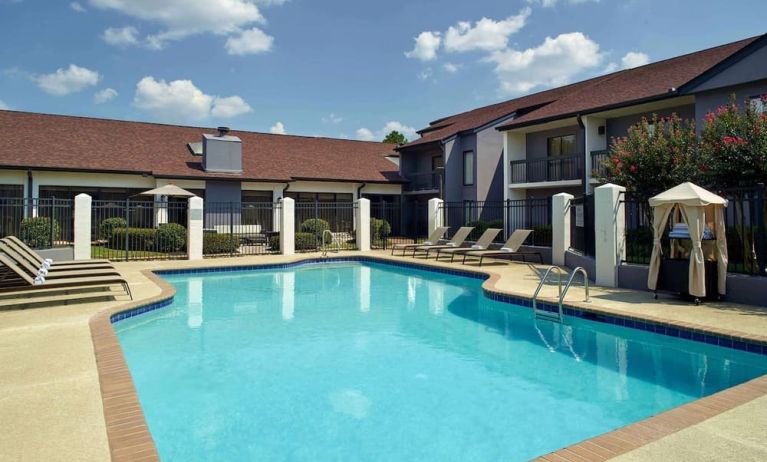 Outdoor pool with lounge chairs at Sonesta Select Atlanta Norcross I-85.