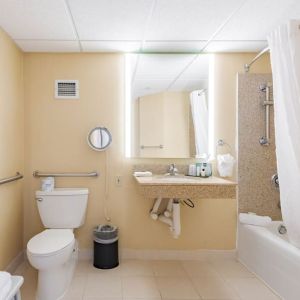 Private guest bathroom with combined shower and tub at Wyndham Omaha.
