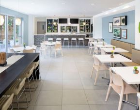 Dining area an on-site bar at Element Miami International Airport.