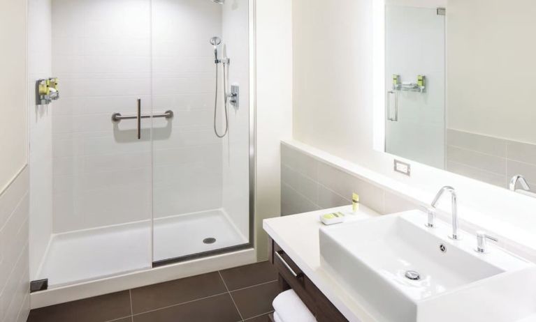 Private guest bathroom with shower and free toiletries at Element Miami International Airport.
