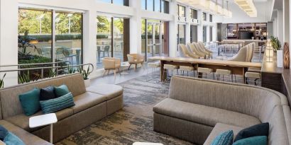 Lobby lounge seating and workspace at Element Miami International Airport.