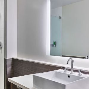 Private guest bathroom with shower at Element Miami International Airport.