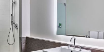 Private guest bathroom with shower at Element Miami International Airport.