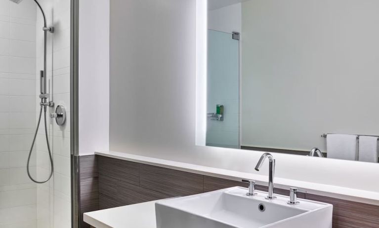 Private guest bathroom with shower at Element Miami International Airport.
