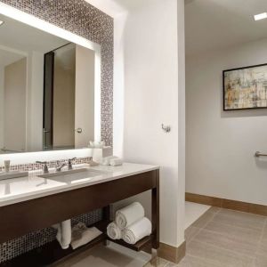 Private guest bathroom with free toiletries at Hilton Dallas/ Plano Granite Park.